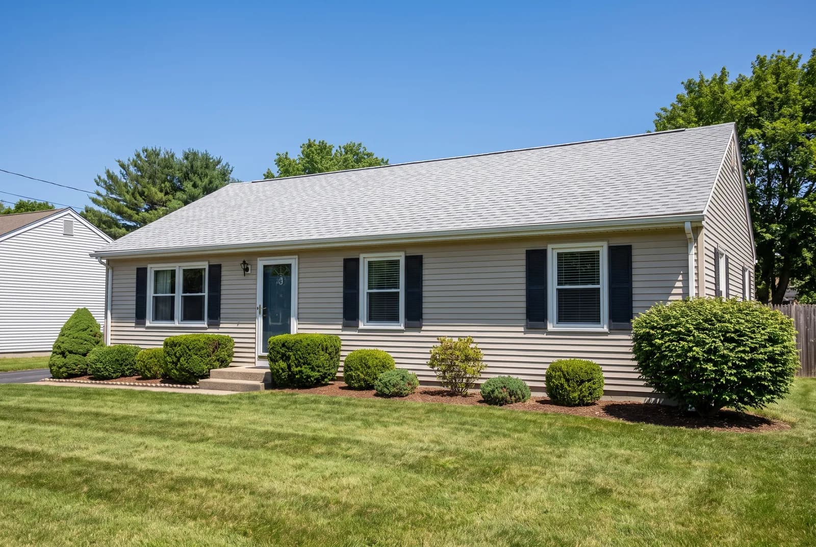 Tudor cottage with a steep, uniform 3-tab shingle roof